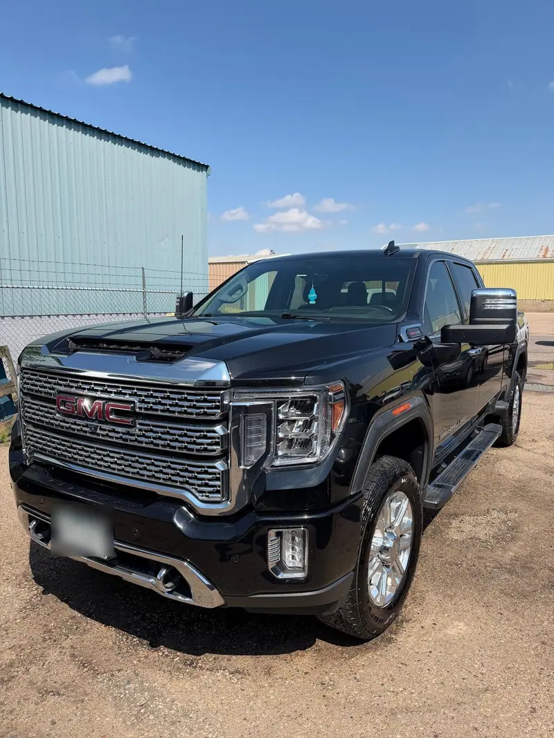 Black GMC Sierra Denali pickup after an exterior detail, paint and chrome shining