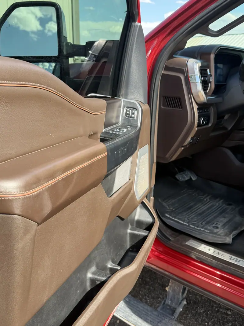 Ford pickup door open showing a cleaned leather door panel and floor
